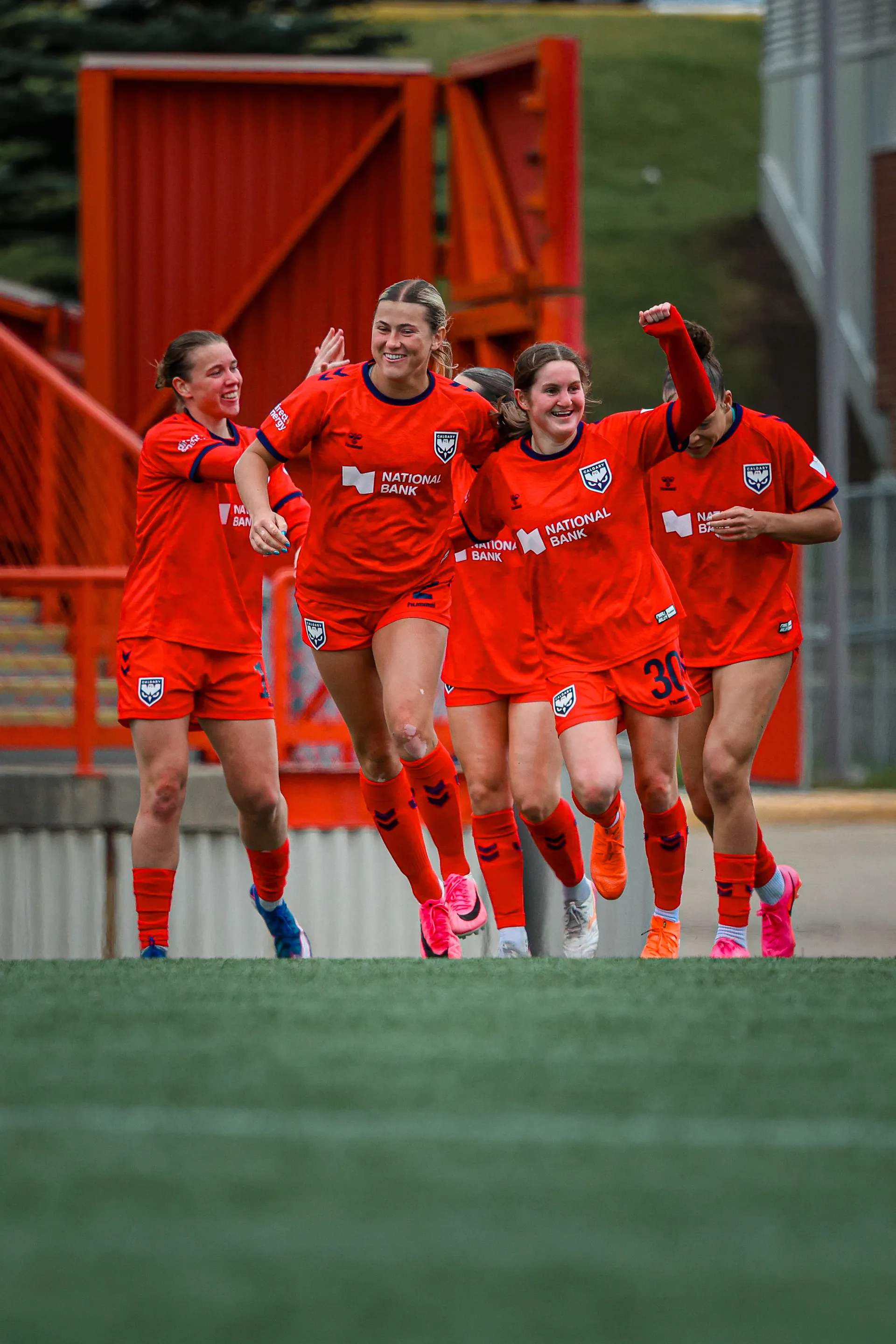 Taegan Stewart celebrates with Calgary Wild FC teammates after scoring against Halifax Tides FC