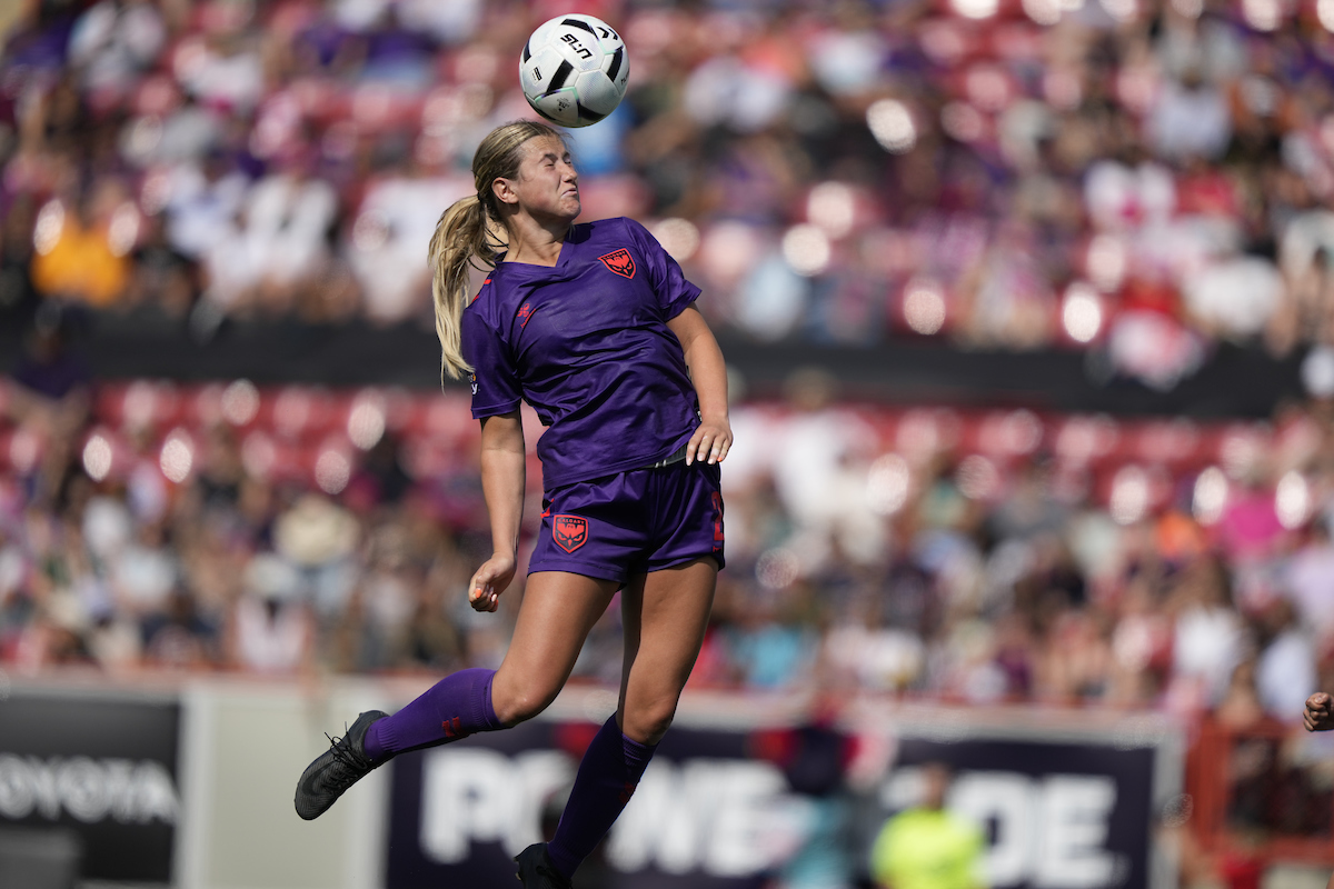 Grace Stordy headbutts a ball during a match