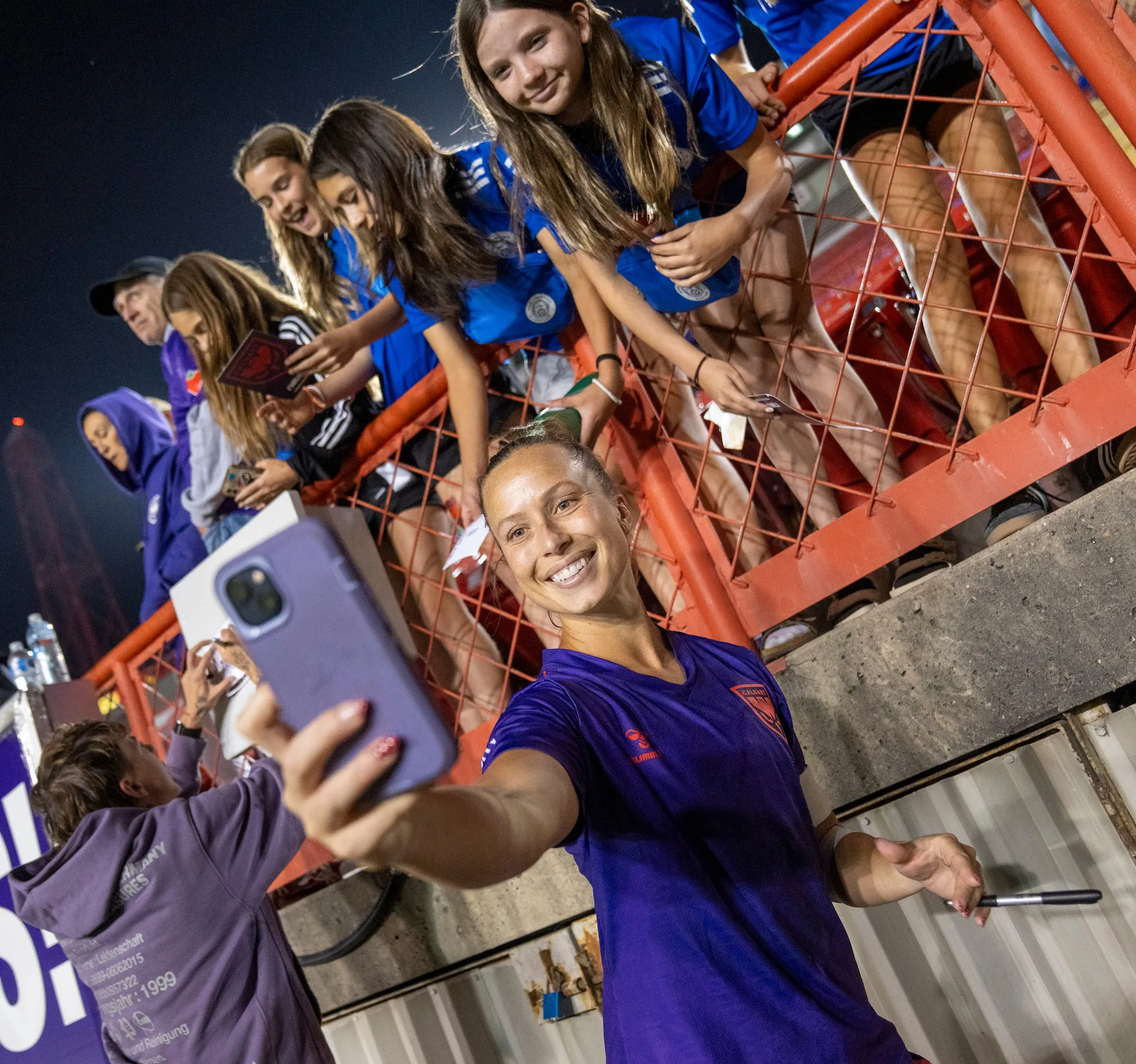 A player taking a selfie with a fan during the group ticket experience